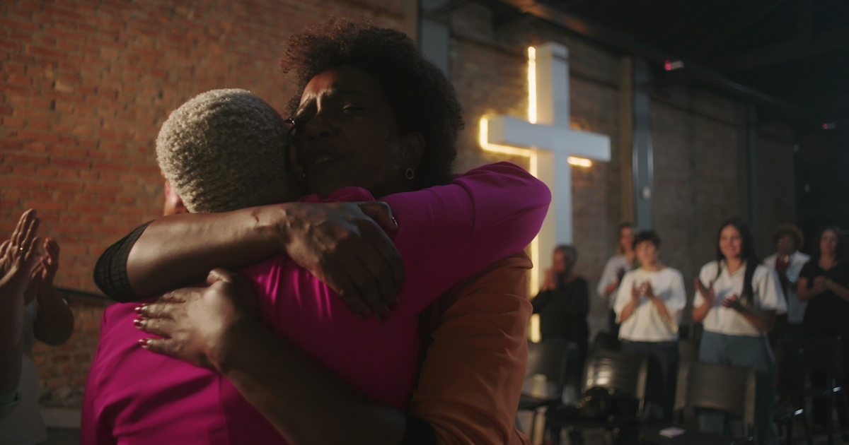 Two women hug in a church